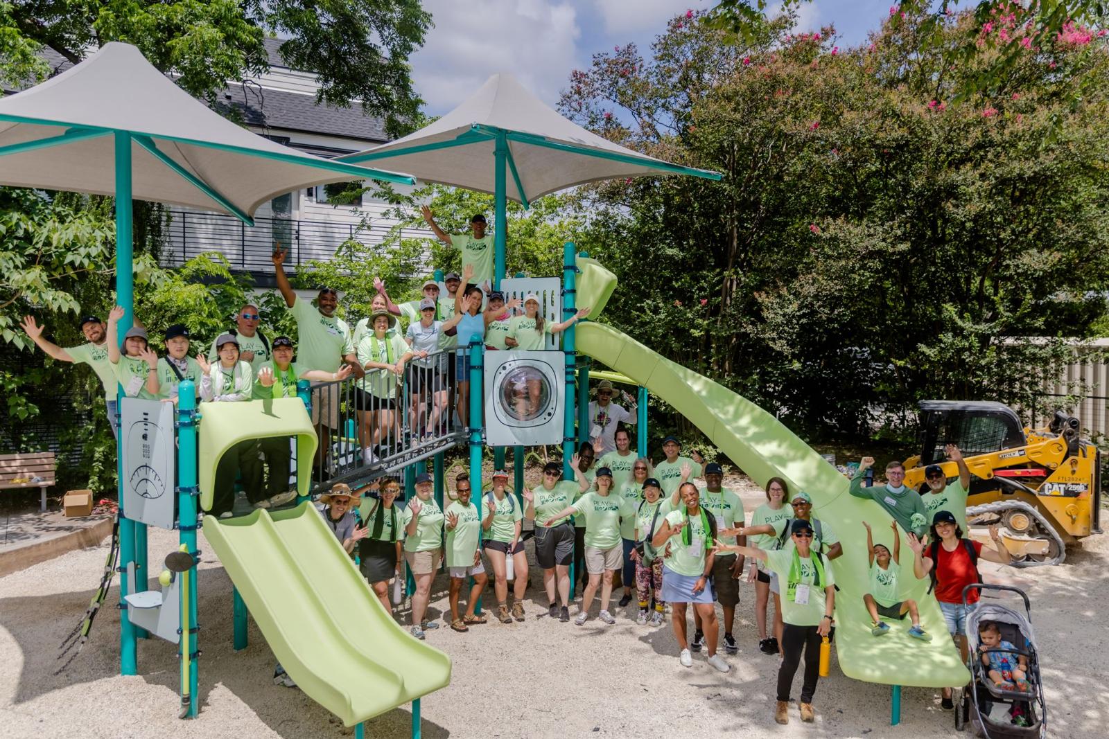 Volunteer group celebrating finished playground